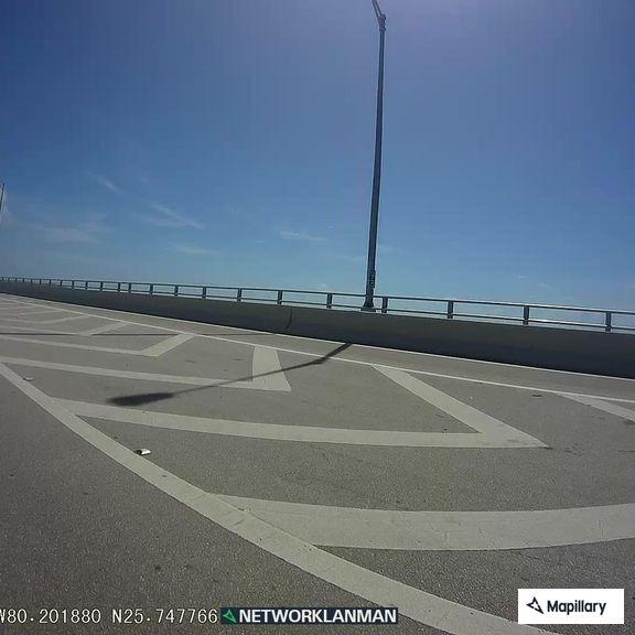 Illegally parked vehicles block lane on causeway