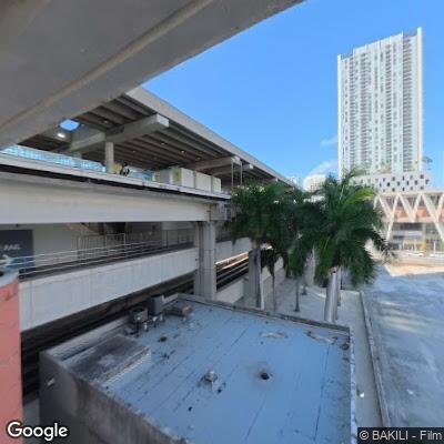 Female experiencing abdominal pain outside Miami library