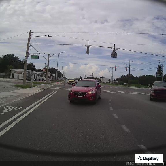 Driver runs red light and throws items at car