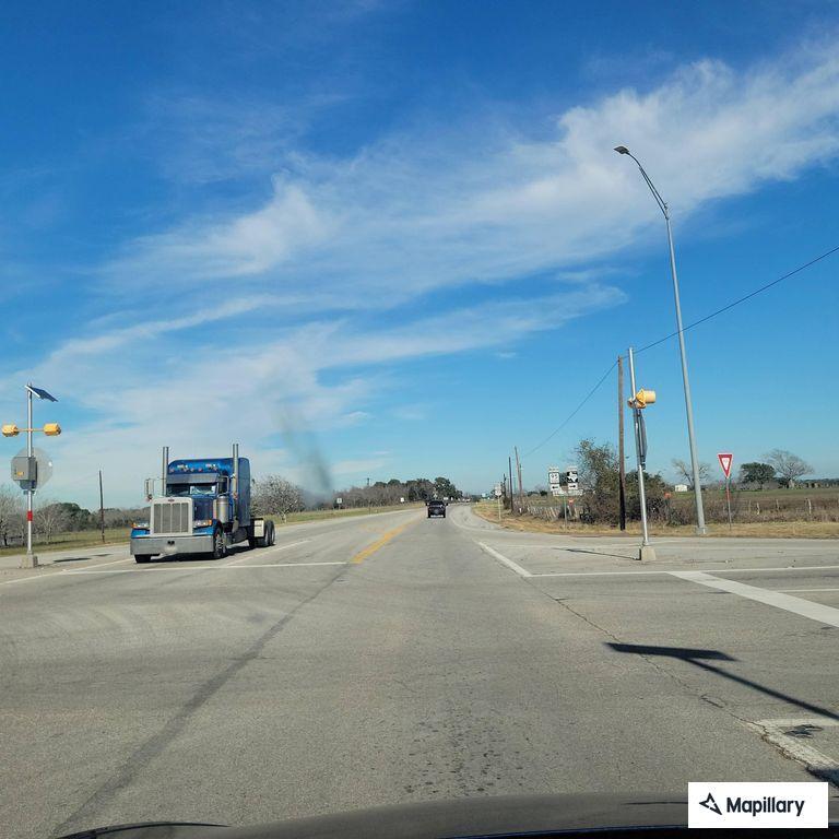 Man walking in highway traffic, throwing objects