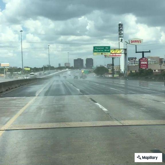 Officer checks pickup truck on freeway shoulder