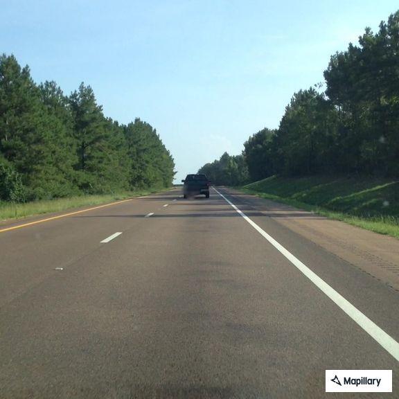 Car with flat tire on I-55 near Bogue Chitto
