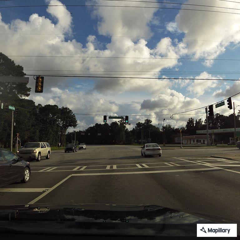 Traffic stop on gray Jeep at highway intersection