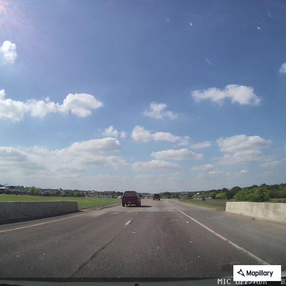 Semi-truck driving on highway with blown tire