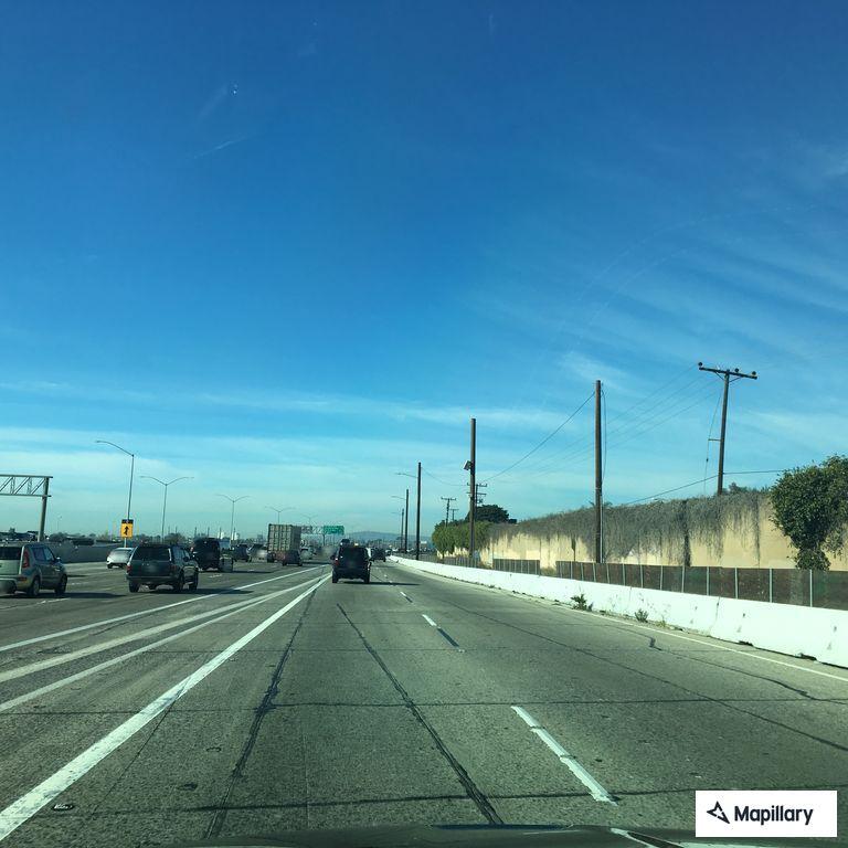 Pedestrian walking on freeway shoulder