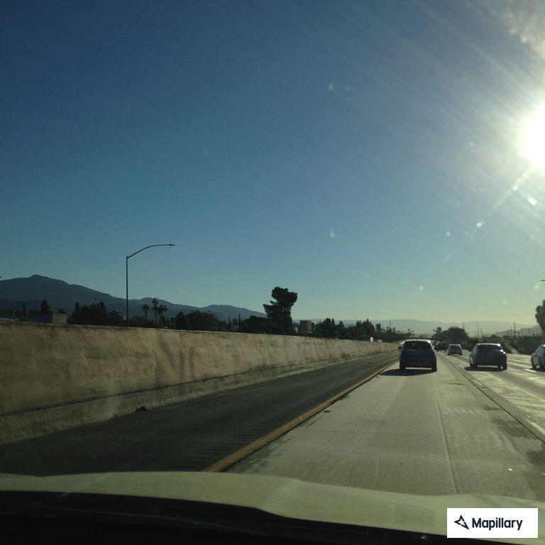 Brush fire in wash south of freeway