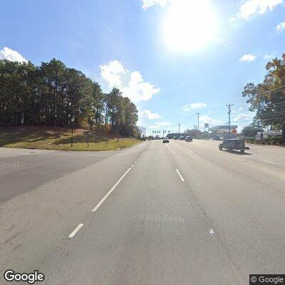 Person with shopping cart in road median