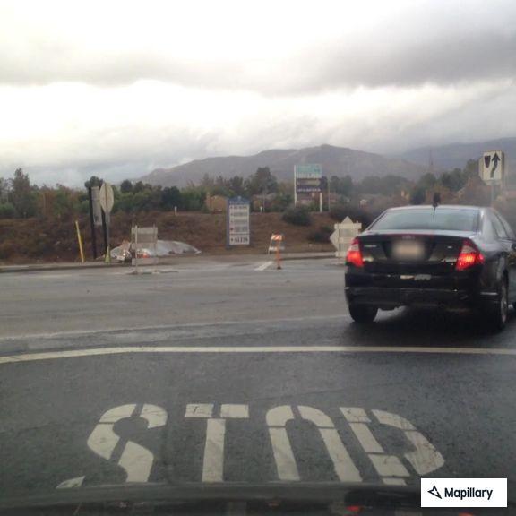 Driver in white Honda traveling slowly on Juniper Avenue