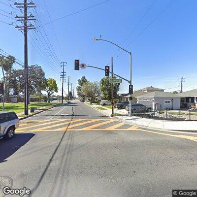 Two adults take water from open manhole at Pico Park