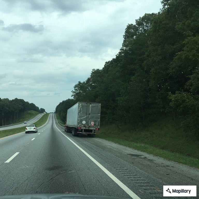 Officer escorting driver to highway exit