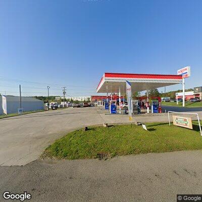 Person hides items by dumpster at Exxon station