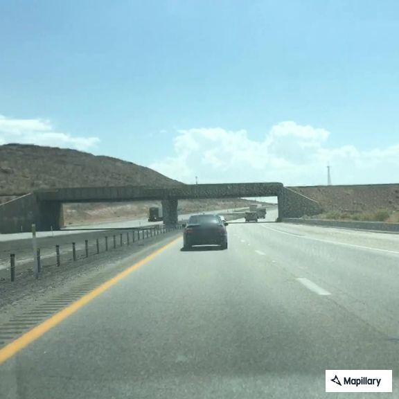 Stopped black Tesla on I-15 southbound off-ramp