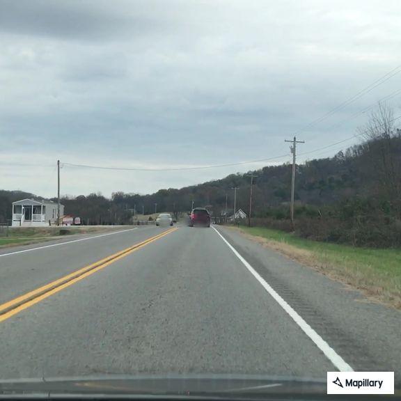 Truck hauling trailer with loose wheel on Highway 10