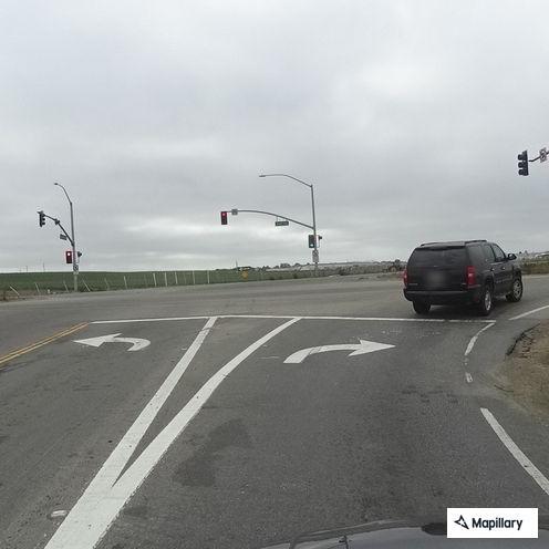 Dark red sedan hits center divider on Highway 101