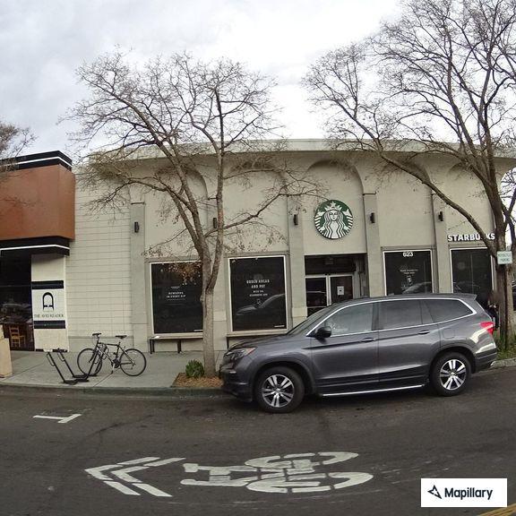 Car crashes into business, man hurt on sidewalk