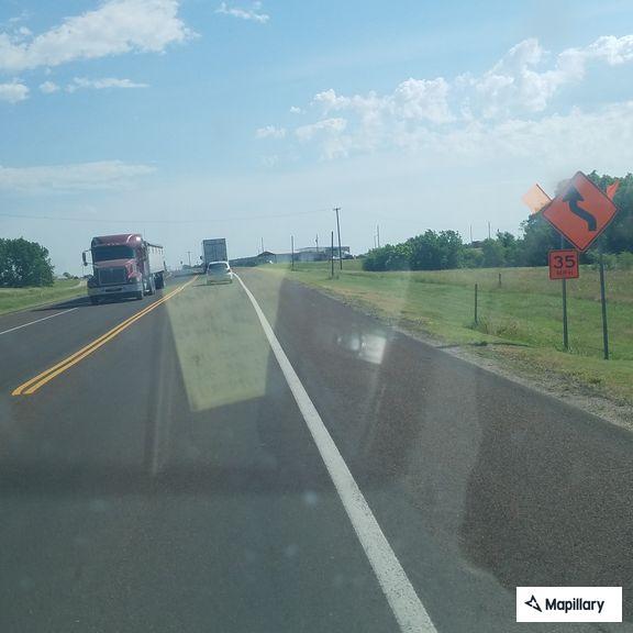 Car in ditch along Highway 156 near Third Street
