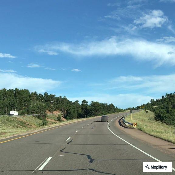 Minivan with trailer crashes off West Highway 24