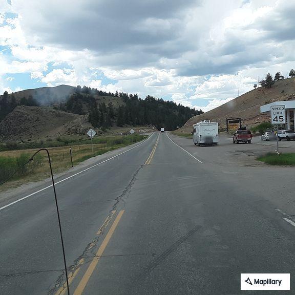 Elderly woman walking along Highway 24 in Hartsel
