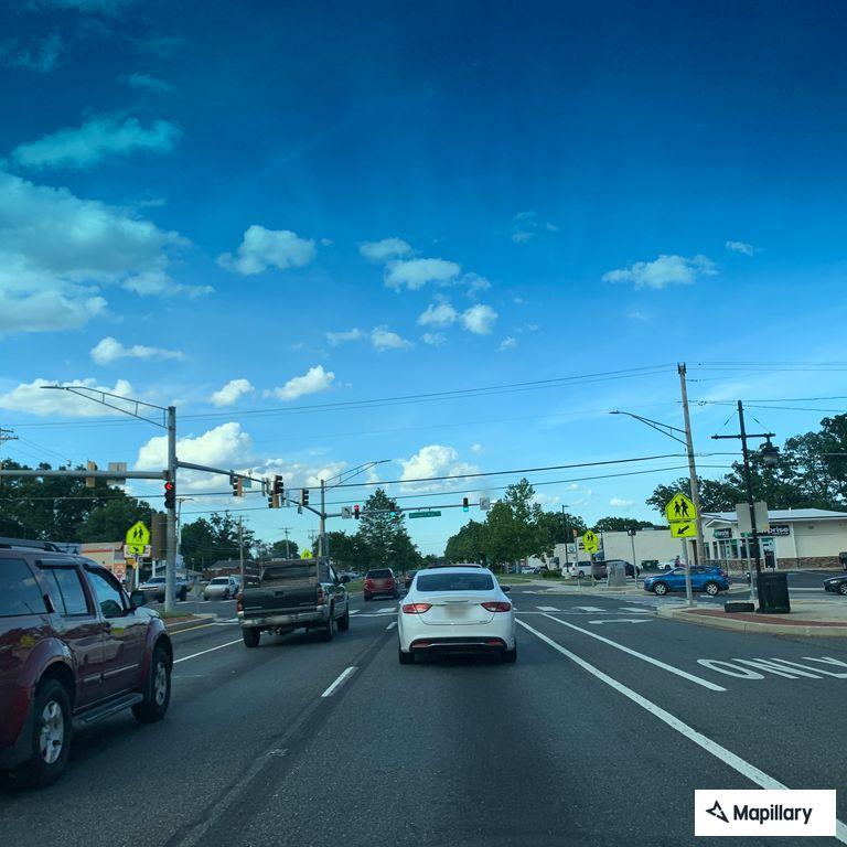 Woman walking in traffic without shirt