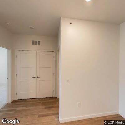 Neighbors yelling insults in apartment hallway
