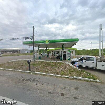 Person down on knees at gas station near blue van