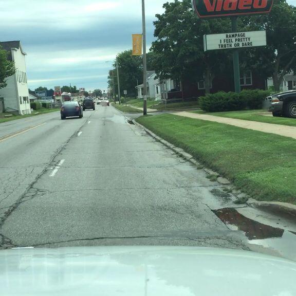 Officers check vehicles with dealer plates at lot