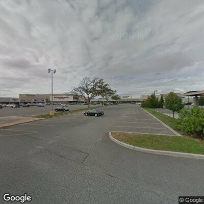 Person lying on sidewalk at Southport Shopping Center