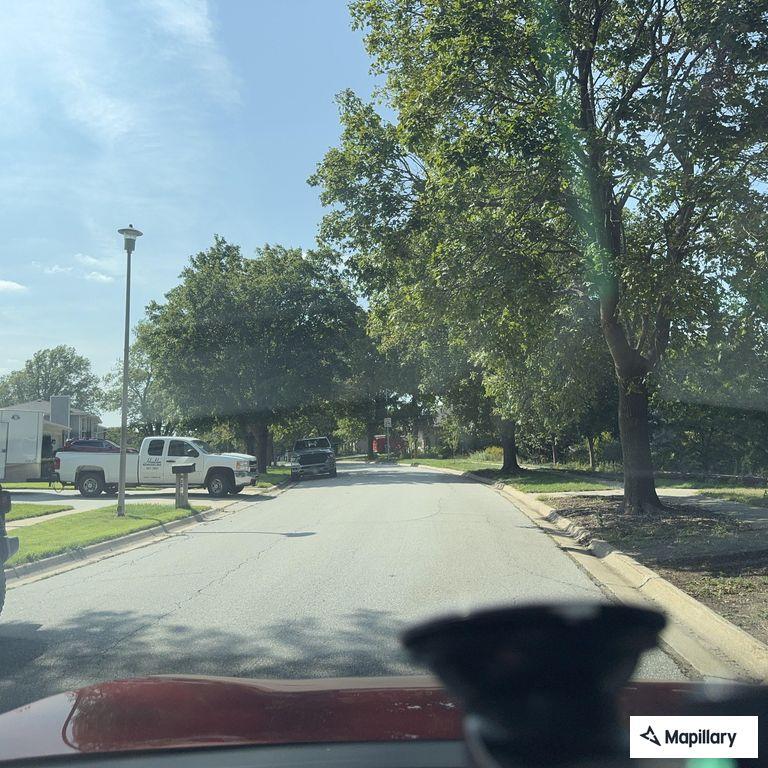 Red pickup speeding through traffic on 84th and South