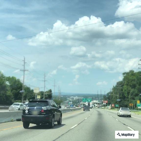 Car hits deer and begins smoking on highway ramp