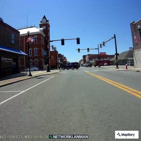 Car driving without headlights on Main Street