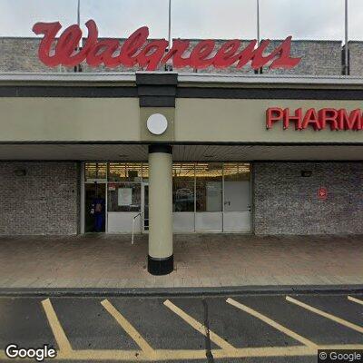 Man in fifties lying in front of Walgreens for check