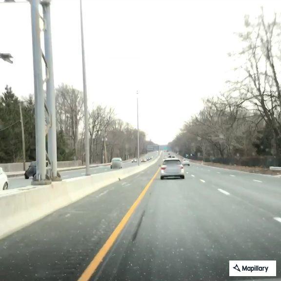 Young man hitchhiking near Russell Avenue