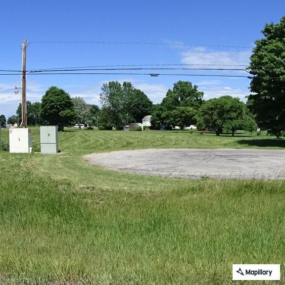 Motorcycle crash in gravel outside business
