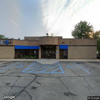 Male with head cut in front of local bank