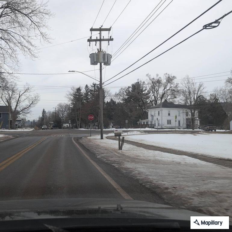 Truck spills gravel and blocks Maple Street roadway