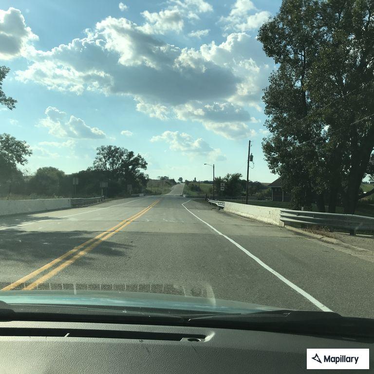 Officer checks on broken down car off roadway