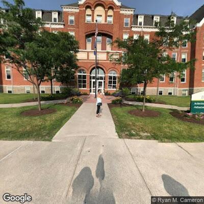 Man walking barefoot and waving stick at caller