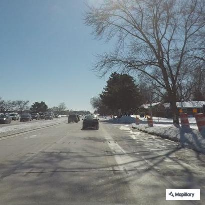 Blue SUV with flat tire blocking traffic
