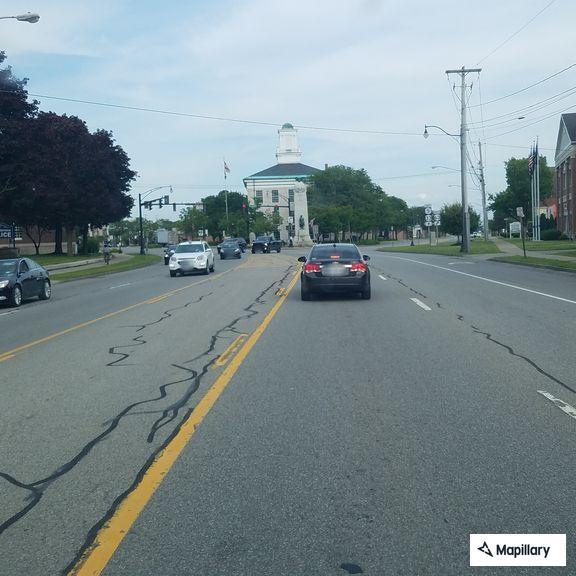 Unknown woman taking photos of vehicle on Porter Ave