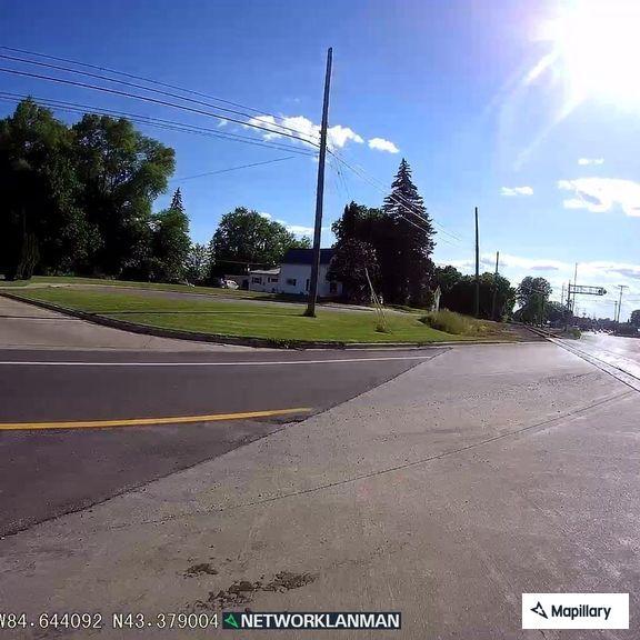 Pickup runs red light and drives off roadway