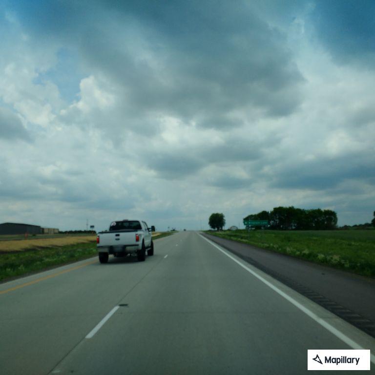 Driver reports blue box truck crossing center line