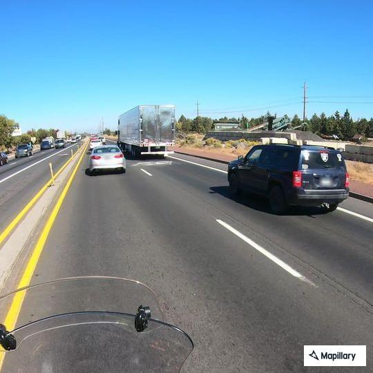 Motorcycle weaving through traffic on Highway 97