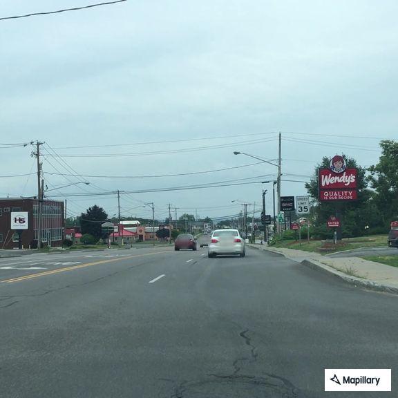 Officer checks red car near Chick-fil-A on Route 3