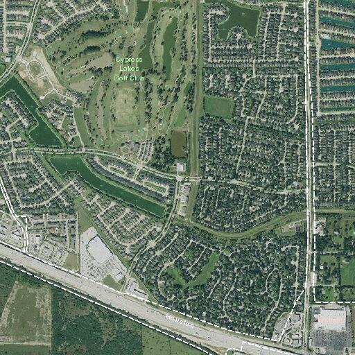 Person walking in roadway pulling suitcase near Costco