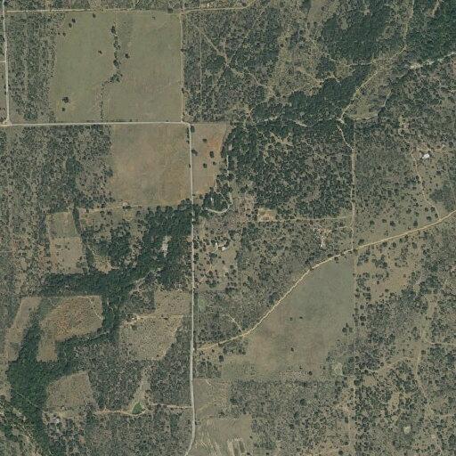 Hay baler and hay bales on fire near Tow, Texas
