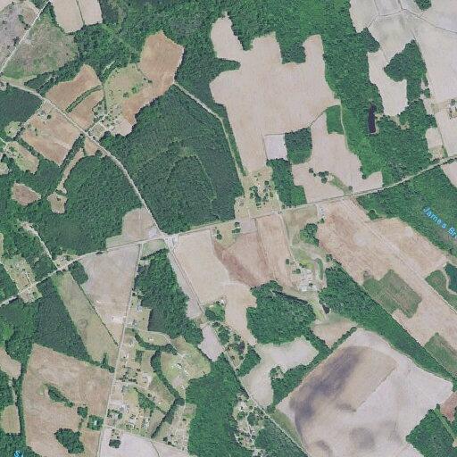 Woods and grass fire near trailers on rural road