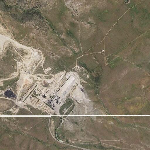 Stranded blue SUV on dirt road near cement plant