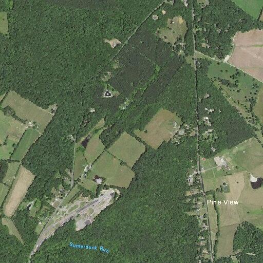 Controlled barn fire near wood line at farm