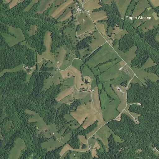 Construction fire smoldering in field near house site