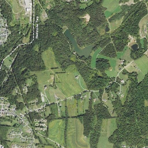 Man riding quad through yard on Twin Hills Road